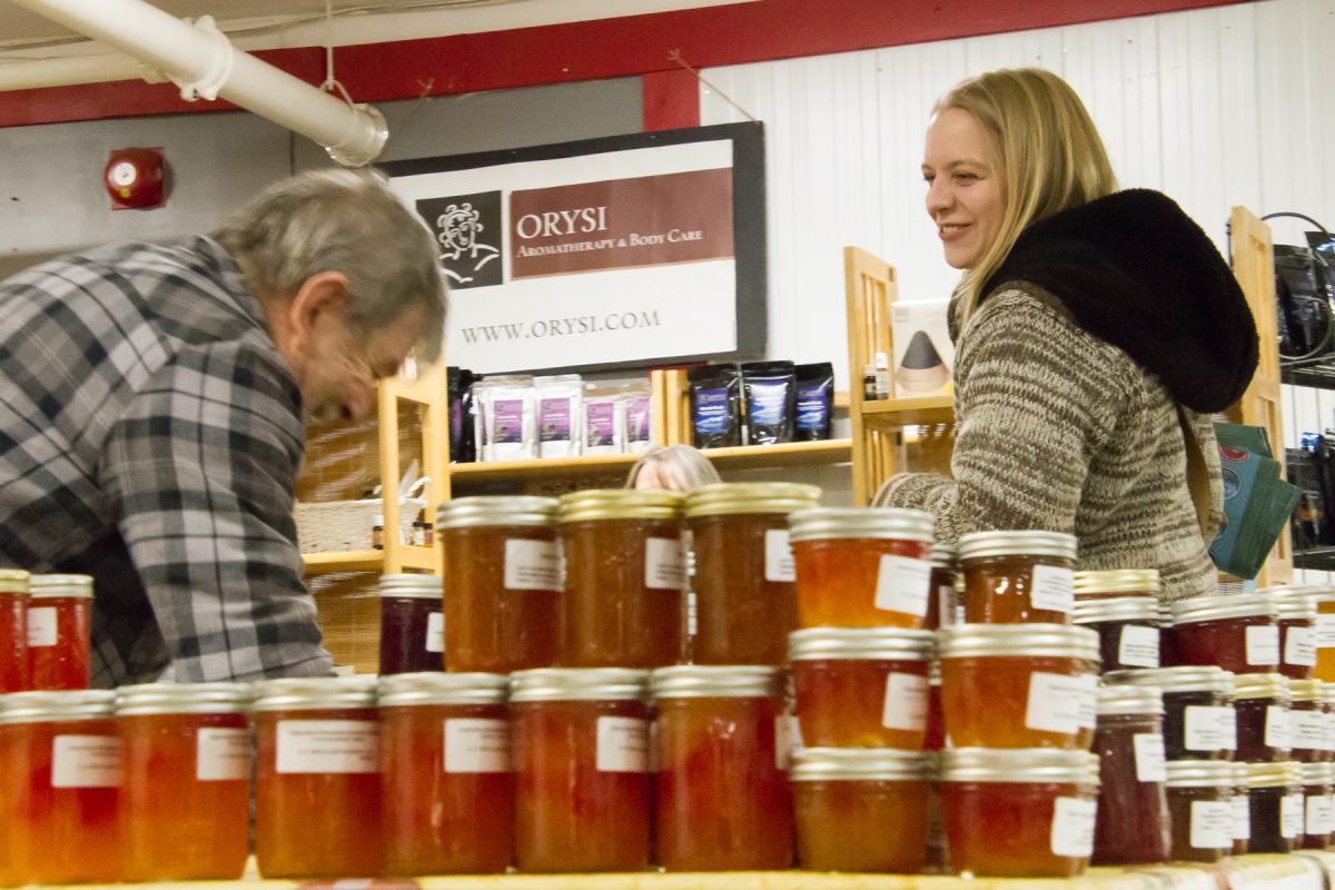 Jars of jam pictured, with smiling customers enjoying The Thunder Bay Market